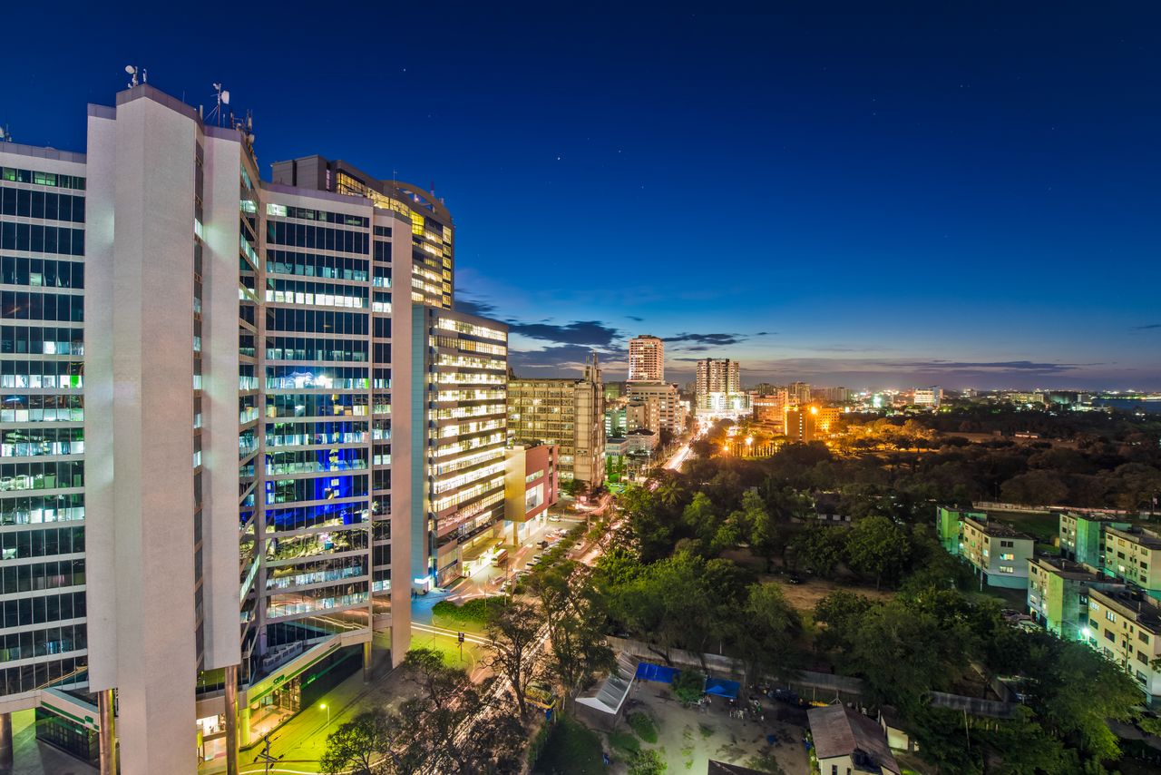 The Art of Drawing Readers In: Your attractive post title goes here Dynamic night skyline of Dar es Salaam, showcasing illuminated city architecture.